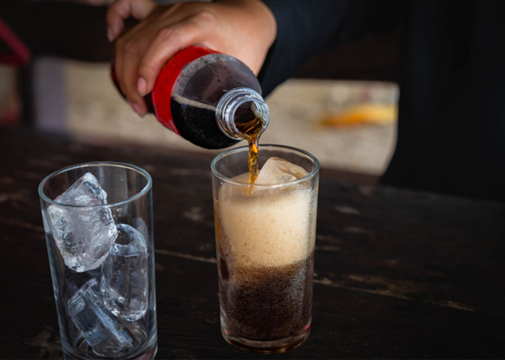 Premium ice cubes from Midwest Ice Masters being used to serve fresh cola drinks in Wichita restaurant, showcasing quality ice delivery service for Kansas businesses
